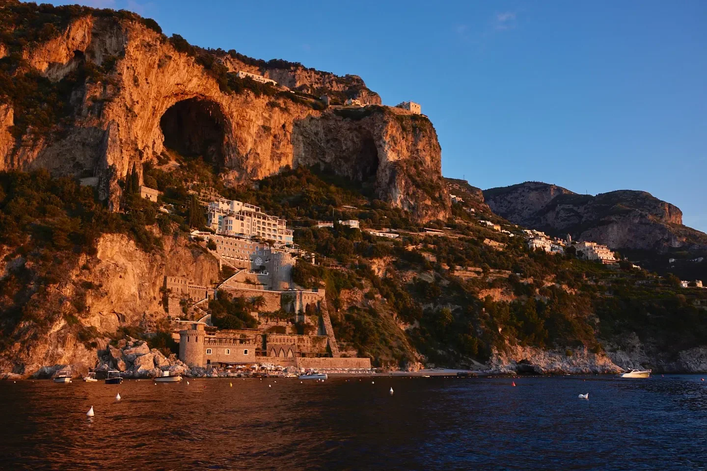 Alici restaurant on the Amalfi Coast, nestled along the dramatic coastline at sunset