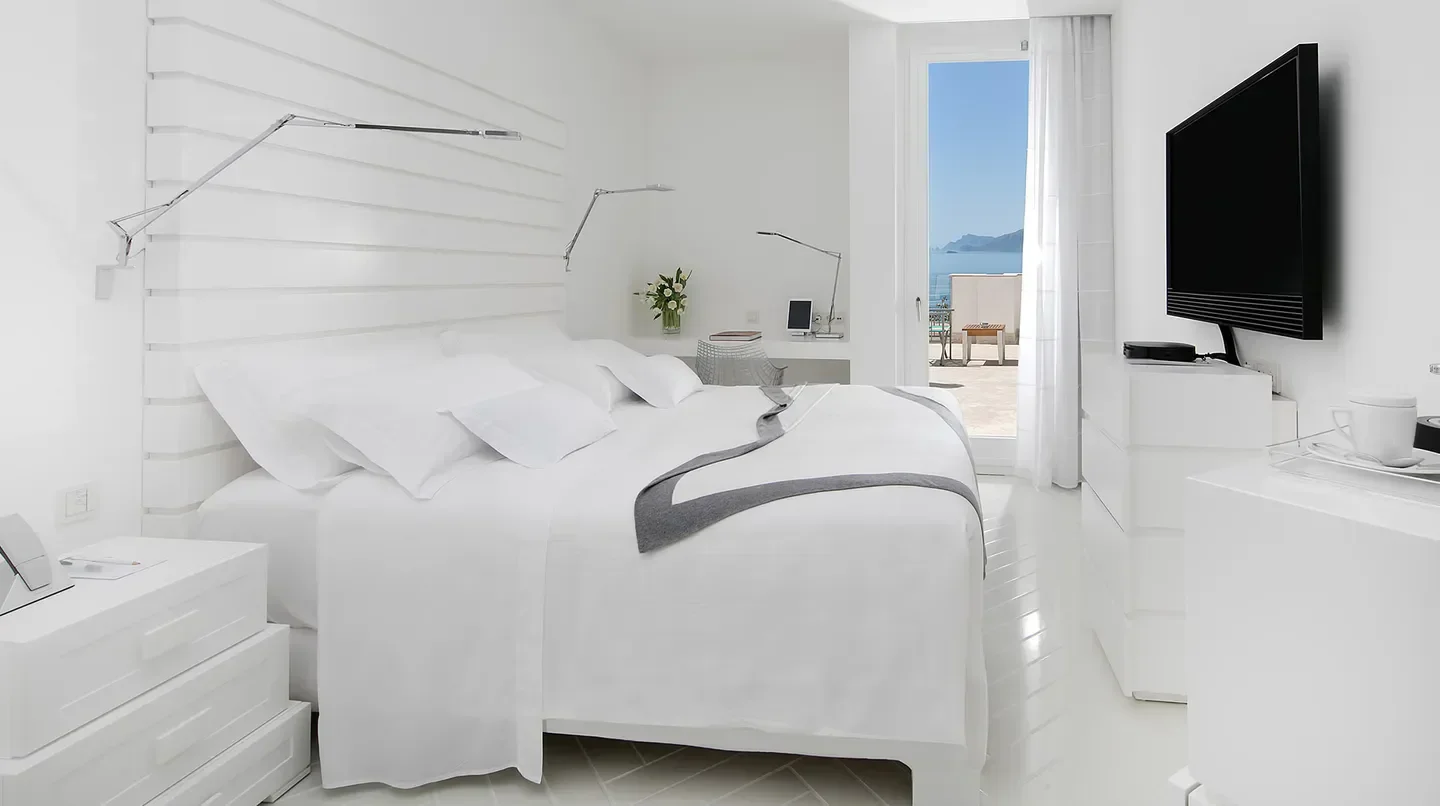 Minimalist bedroom at Casa Angelina hotel with Amalfi Coast views and elegant decor