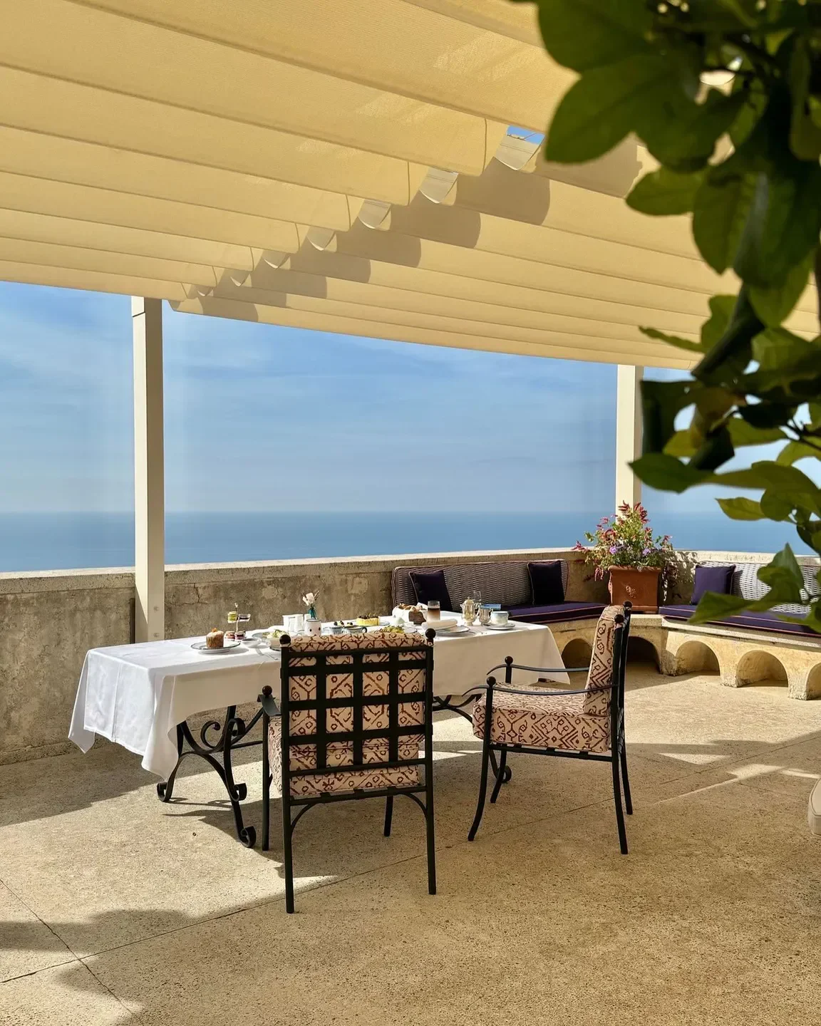 Outdoor dining at Il Refettorio with ocean views on the Amalfi Coast