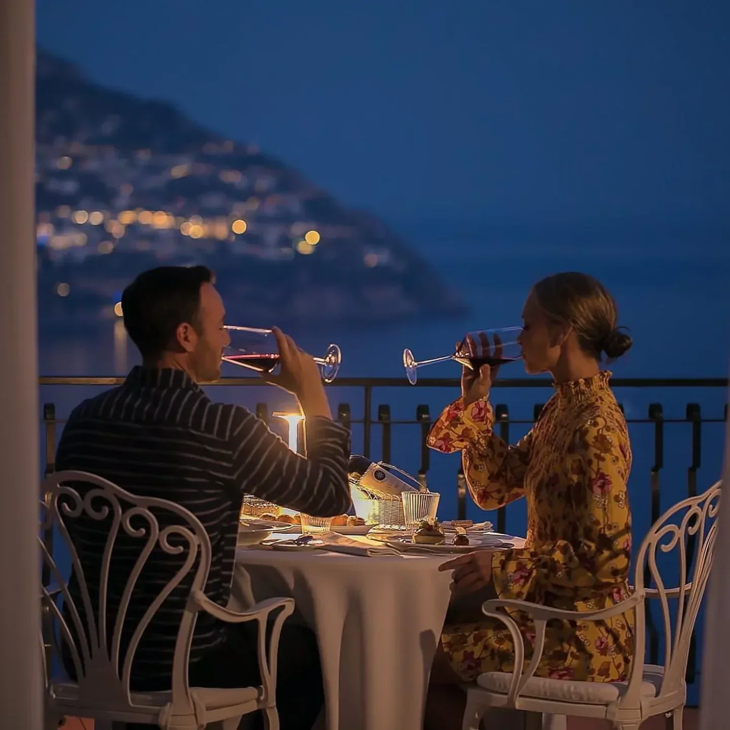 Romantic dinner at La Serra restaurant, Amalfi Coast, overlooking the night lights.