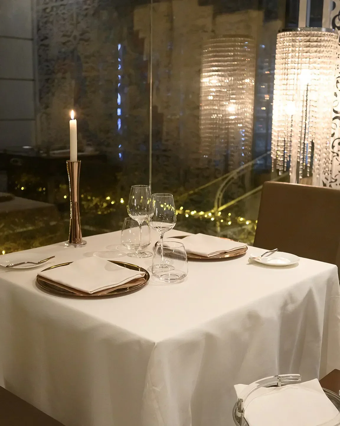 Elegant dining table set at Re Maurì restaurant on the Amalfi Coast with a candlelit ambiance.