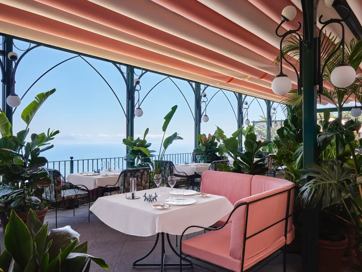 Elegant dining terrace at Rossellinis restaurant overlooking the Amalfi Coast.
