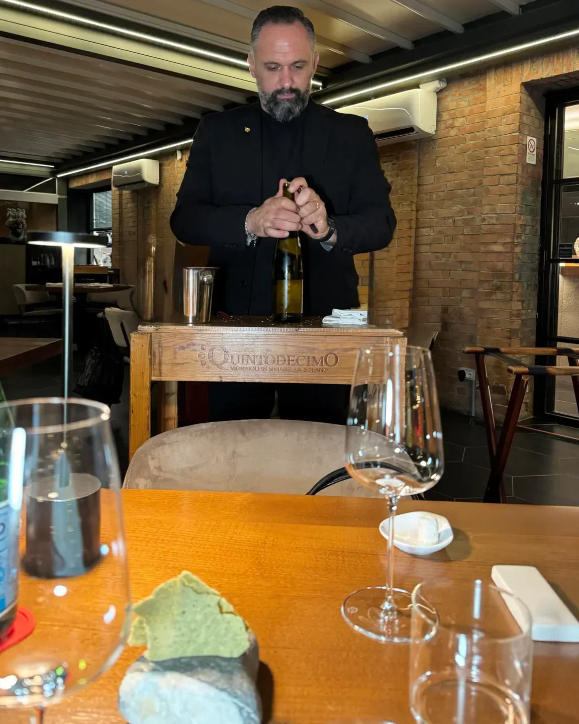 Sommelier opening wine at Suscettibile Salerno, a restaurant in the beautiful Amalfi Coast.