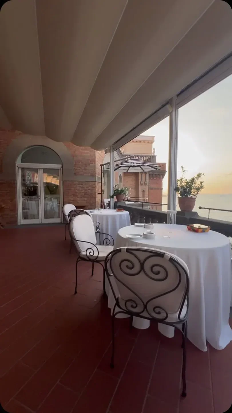 Terrazza Bosquet restaurant on the Amalfi Coast with sunset views and elegant tables.