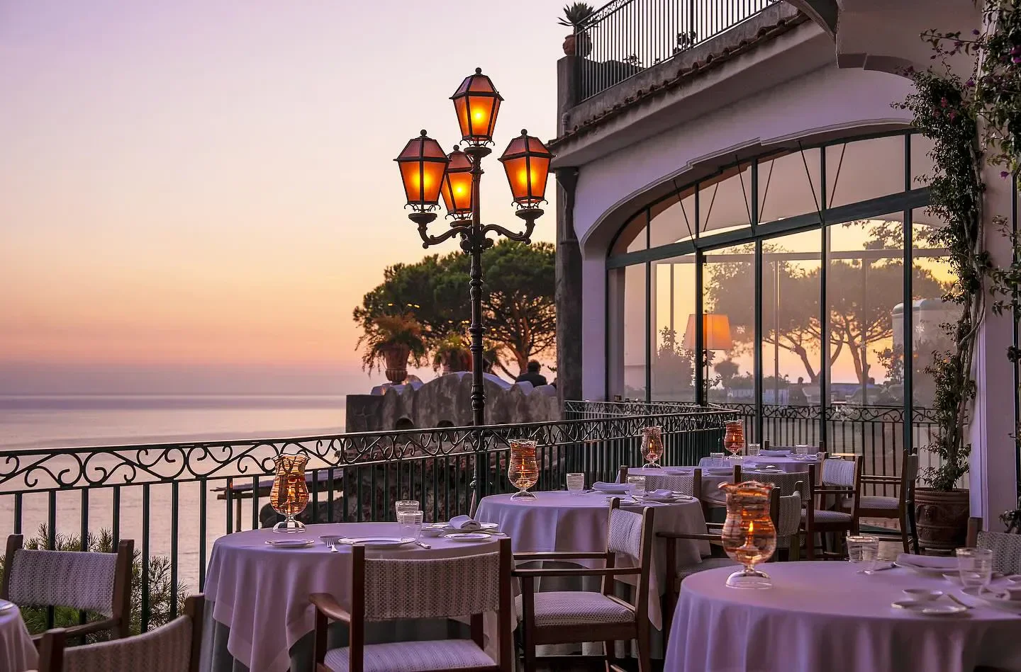 Zass restaurant on the Amalfi Coast at sunset, elegant tables with sea views.